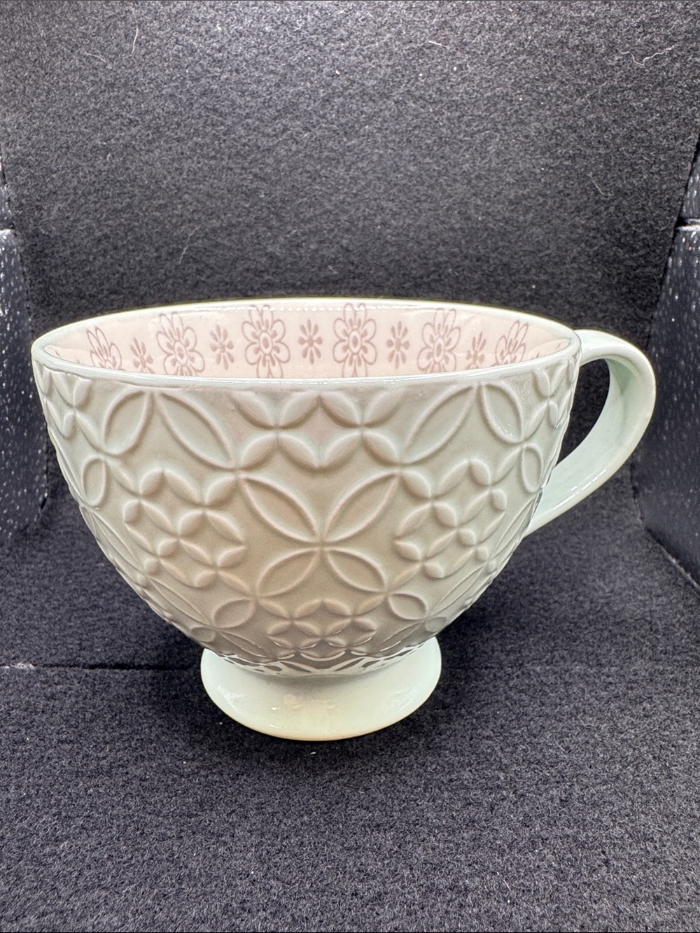 Embossed Signature Brand Coffee Cup in Pale Green with Floral Interior